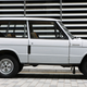 A photo of a white Range Rover three-door marked on a street.